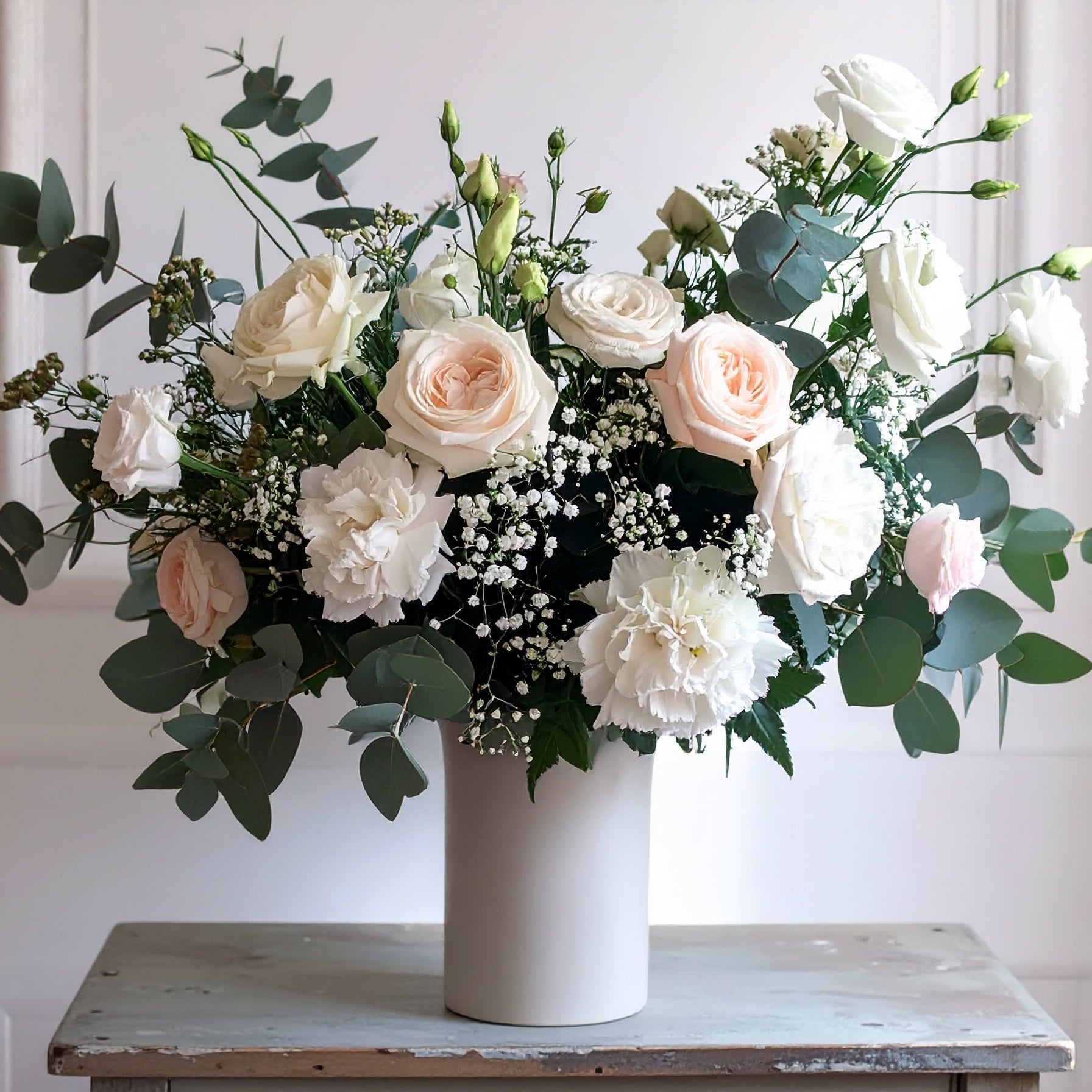 Elegant floral arrangement in classic garden style, ideal for funerals, weddings and celebrations.