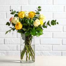 A sleek arrangement of premium assorted roses accented with specialty greenery, styled in a modern, minimalist design. 