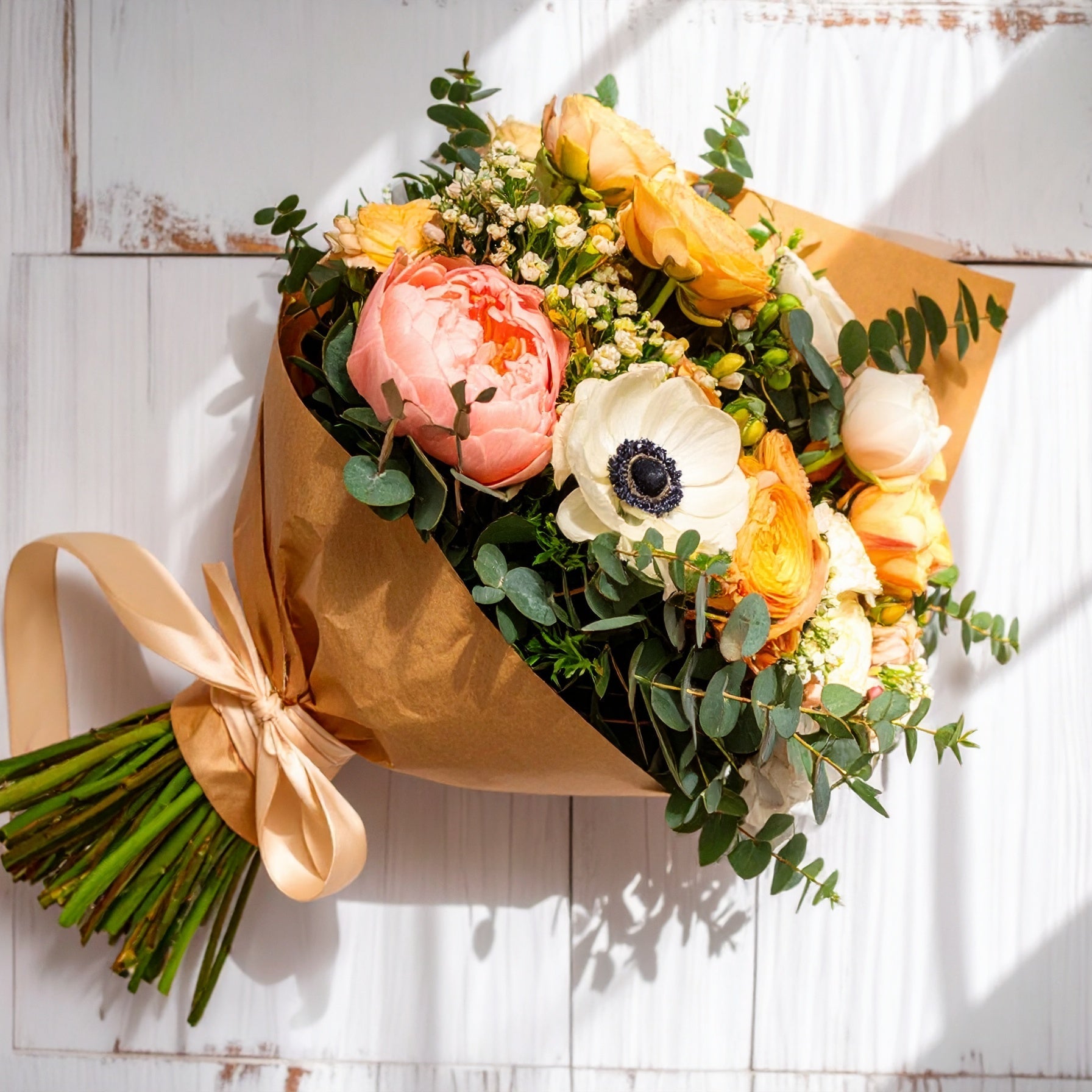 A wrapped bouquet of fresh, seasonal flowers in assorted colours and varieties, uniquely designed with no two arrangements alike.