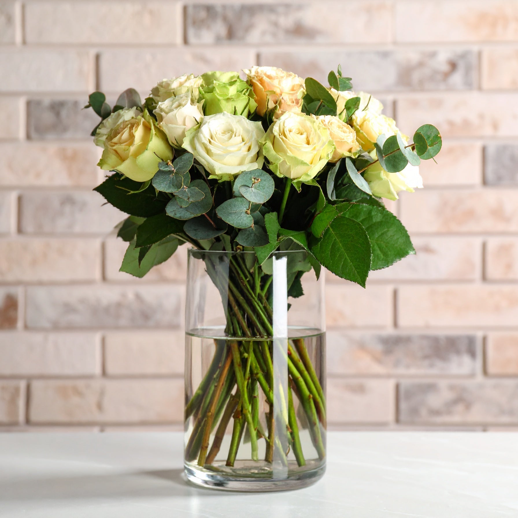 A sleek arrangement of premium white or green Ecuadorian roses accented with specialty greenery, styled in a modern, minimalist design.