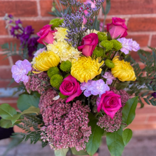 Fresh seasonal flowers in a custom hand-tied bouquet, expertly arranged and wrapped by a florist—unique for every occasion, no vase included.